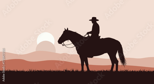 Silhouette of a cowboy riding a horse at sunset.