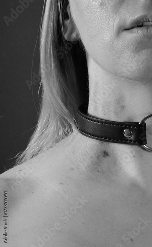 Black Leather Collar On Female Neck Closeup Monochrome Minimalist Photography. Sensual Artistic Portrait With Soft Lighting Detail Contrast Texture
