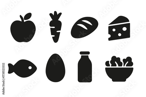Food Icon Set. Solid, filled icon set of food: apple, carrot, bread, cheese, fish, egg, milk bottle, salad bowl. Solid, filled icons in only black color. All