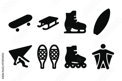 Glide Tools Icons. Solid, filled icon set of glide tools: skateboard, sled, ice skates, surfboard, hang glider, snowshoes, rollerblades, wingsuit. Solid,