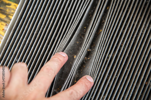 Old dirty carbon cabin filter of the car. Concept of replacement with a new one. Cleaning the air in the car cabin, close-up