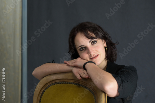 brunette model poses sensually in a photo studio for a fashion magazine