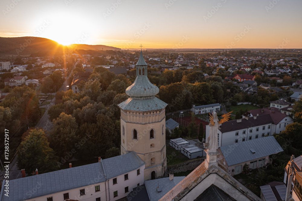 Obraz premium Angel Statue and Historical Tower at Golden Sunset