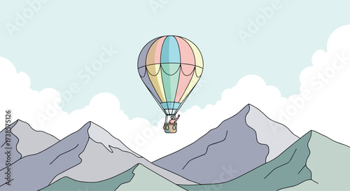 Colorful hot air balloon floats above majestic snow capped mountains