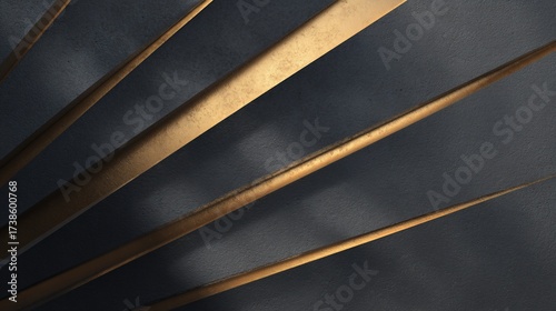 Angular gold bars rise from shadows on a textured wall, suggesting modern design