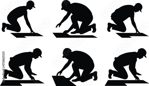 Silhouette of construction workers installing flooring and tiles, manual labor, craftsmanship, precision work, building renovation, construction skill, home improvement