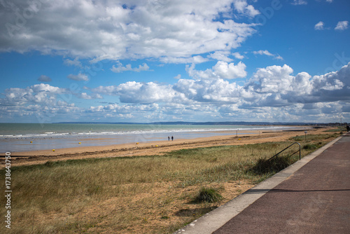 sword beach in Normandy with people strolling along shore