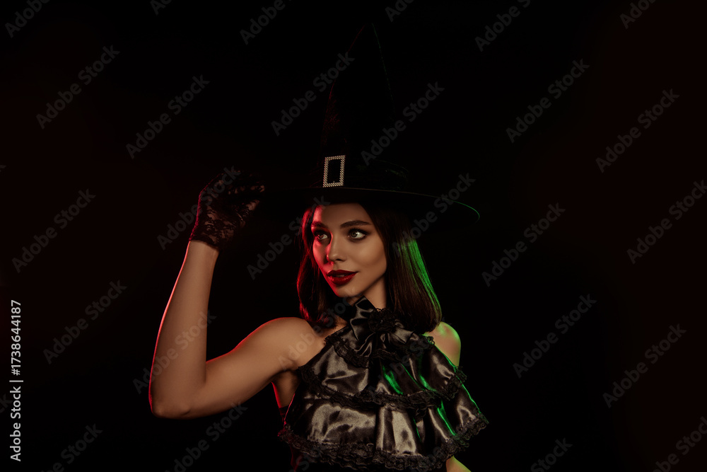 Fototapeta premium Stylish witch in dark attire with a spellbinding look, perfect for Halloween themes and mysterious autumn photography