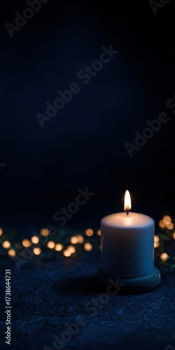Burning candle flame on dark night background