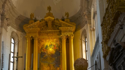 Sunlight illuminating golden altar in church. Sunlight progressively illuminates the golden altar inside the basilica, italy, highlighting its intricate details and religious artwork