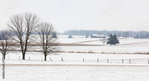 A serene winter landscape unfolds, showcasing a snow-covered field, leafless trees, a distant farmstead with a barn, and a subtle fence line against a muted sky. 