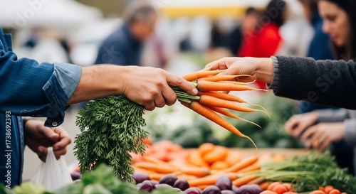 Close-up of hands exchanging a bunch of fresh carrots at a bustling outdoor market; blurred background shows other produce and shoppers