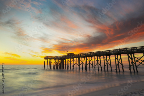 A dramatic, colorful, pastel sunset over the Gulf of Mexico at St Andrew's Pier, Panama City Beach, Florida