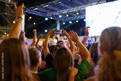 Canvas Print A person recording a video with a phone at the Festival of Unity and Hope at the Piazza del Popolo in Rome, as part of the Jubilee of Youth
