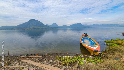 Colorful Wooden Boats Docked on a Lake with Mountain Background. Jatiluhur reservoir of Purwakarta. 