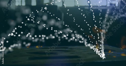 Glowing forge fire pulsing, releasing sparks, forming dynamic parabolic arcs over steel platform