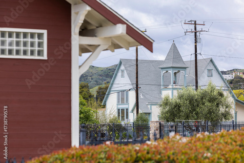 Картината върху платно Cloudy afternoon sun shines on a historic church in the heart of downtown Santa Paula, California, USA