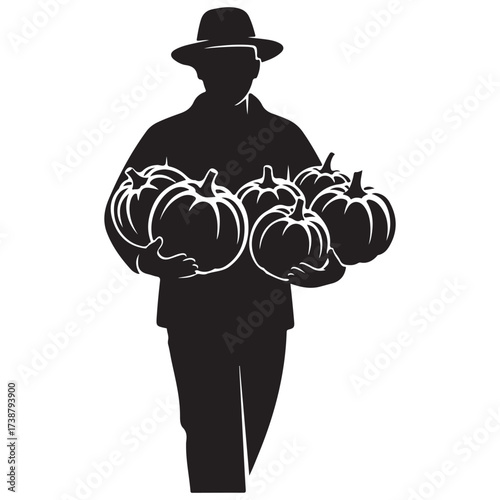 Silhouette of a farmer wearing a hat carrying a bountiful harvest of pumpkins in his arms during autumn