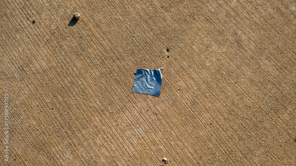 Obraz premium Piece of Duct Tape on Sidewalk Surface