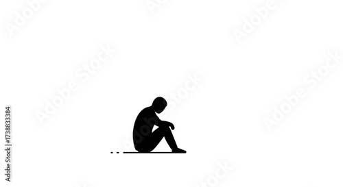 Silhouette of a person sitting alone with their head down, conveying feelings of sadness, depression, or loneliness.