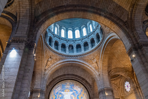Interior view of a grand church dome with mosaic.
