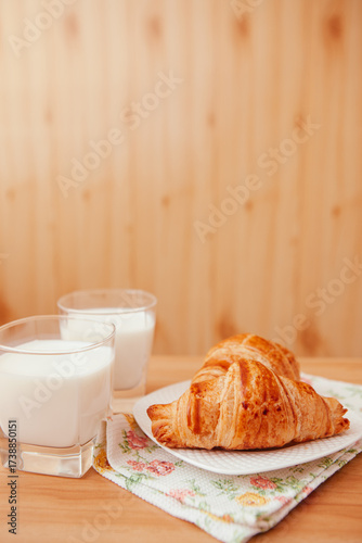Milk and Croissants on the table as a delicious breakfast, vertical card with copy space	