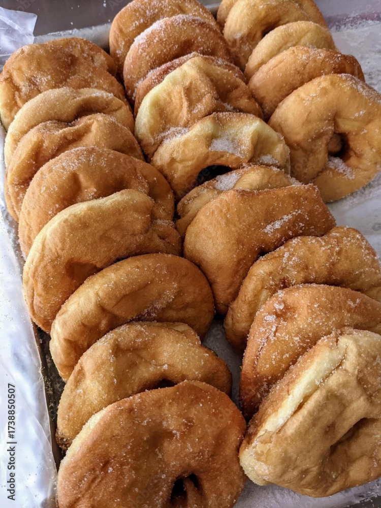 Fototapeta premium Freshly fried doughnuts dusted with sugar.