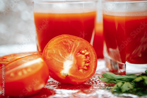Tomatoes and red juice on the glittering background