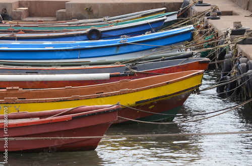 Wallpaper Mural Colorful fishing boats in harbor with vibrant hues against calm water Torontodigital.ca