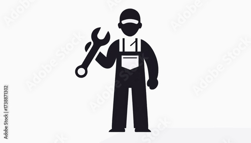 Mechanic holding a large adjustable wrench standing upright.