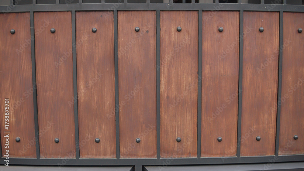 Fototapeta premium Rustic Brown Wood and Black Metal Panel with Decorative Studs