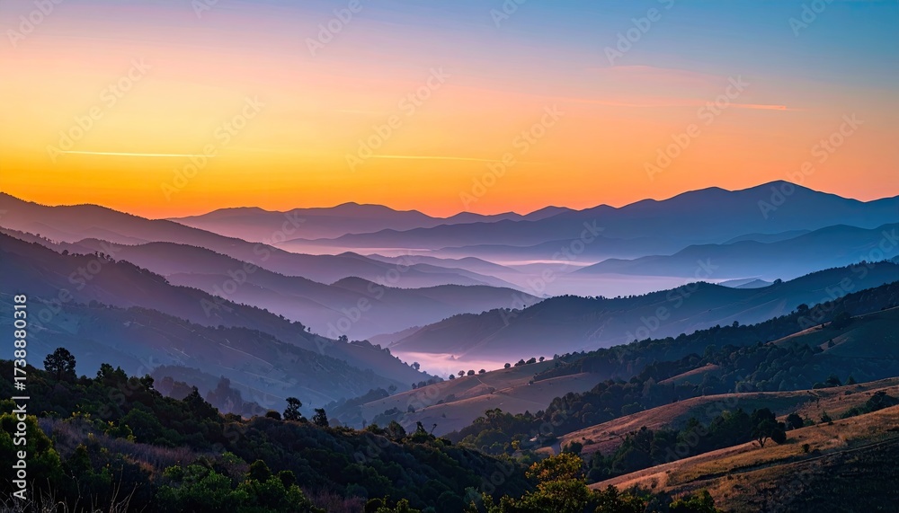 Fototapeta premium Serene Mountain Range at Sunrise with Colorful Sky and Misty Valleys Aerial View