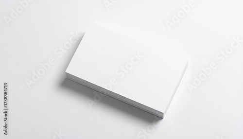 Plain white square paper on a white surface perfect for use as business card with copy space for text and design