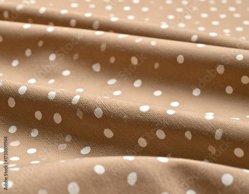 Close-up of a brown fabric with white polka dots, creating a pattern.