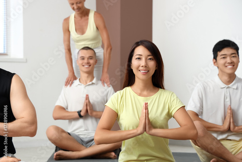 Sporty Asian woman meditati...