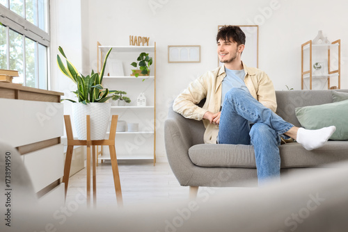Dreaming young man sitting ...