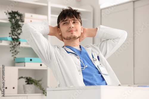 Dreaming male doctor at des...