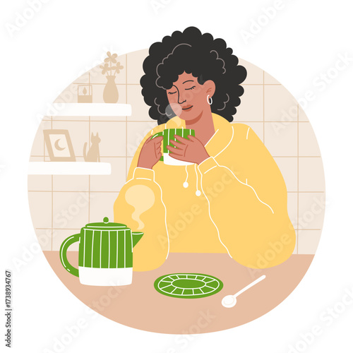 Woman drinks tea in kitchen with kettle and decorations