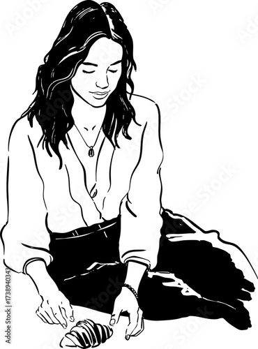 Woman with dark wavy hair sitting and looking at a croissant