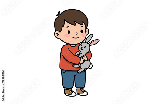 Young boy holding a gray rabbit with a happy expression indoors  