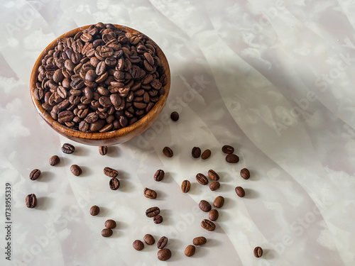 coffee beans in a wooden bowl on a marble table