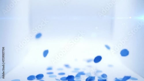 Blue Confetti Particles Floating Gently Against a Bright Abstract Scene