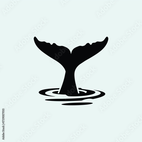 Bold black vector silhouette of a whale tail diving into rippling water graphic design silhouette White background