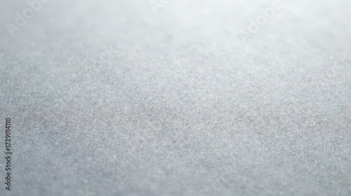 Close-up view of a subtly textured, lightly reflective surface with a muted gray tone, ideal for design backgrounds and subtle graphic applications.