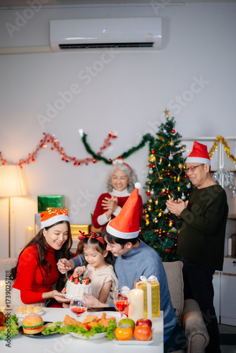 Joyful Asian family gathered for a Christmas feast, exchanging gifts, and celebrating the holiday season with love
