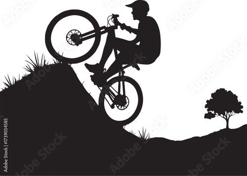 Black silhouette of cyclist doing wheelie on grassy hill