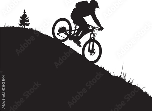 Black silhouette of mountain biker descending grassy hill