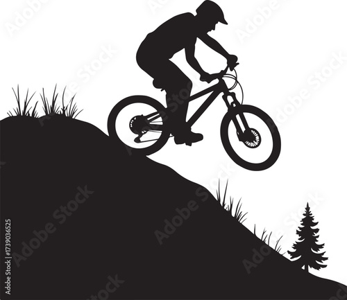 Black silhouette of mountain biker descending grassy hill