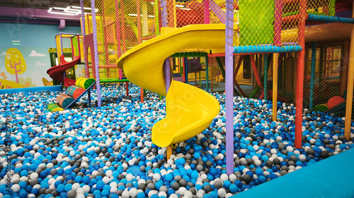 Fotografie Children's entertainment area, a bright playground with safe climbing frames, colorful obstacles and colorful balls