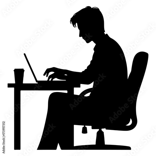 Silhouette of a man working on a laptop at a desk